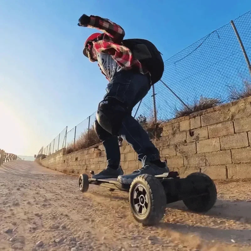 Rider using an OMW Cavalry electric skateboard on a dry rough path