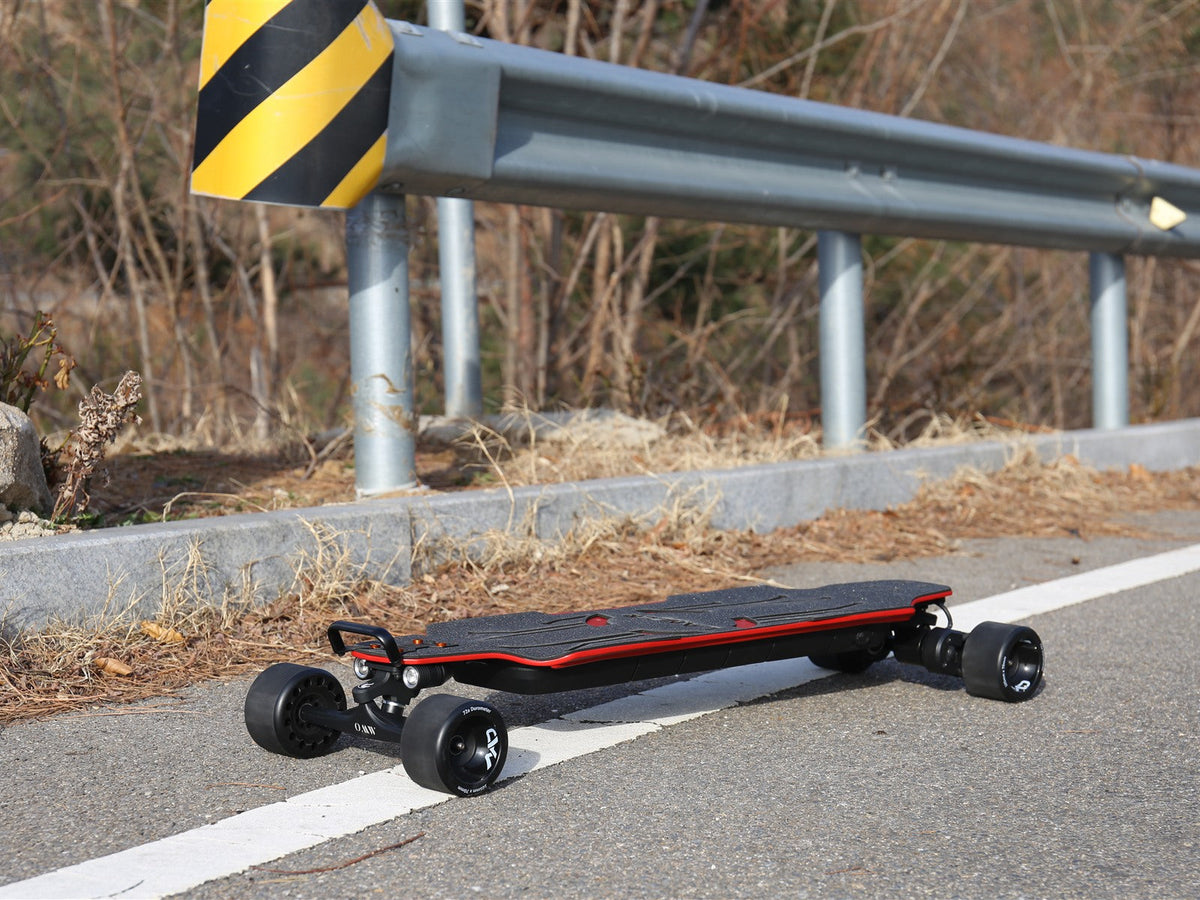 OMW Lancer electric skateboard with 105 mm street wheels on a dry paved route