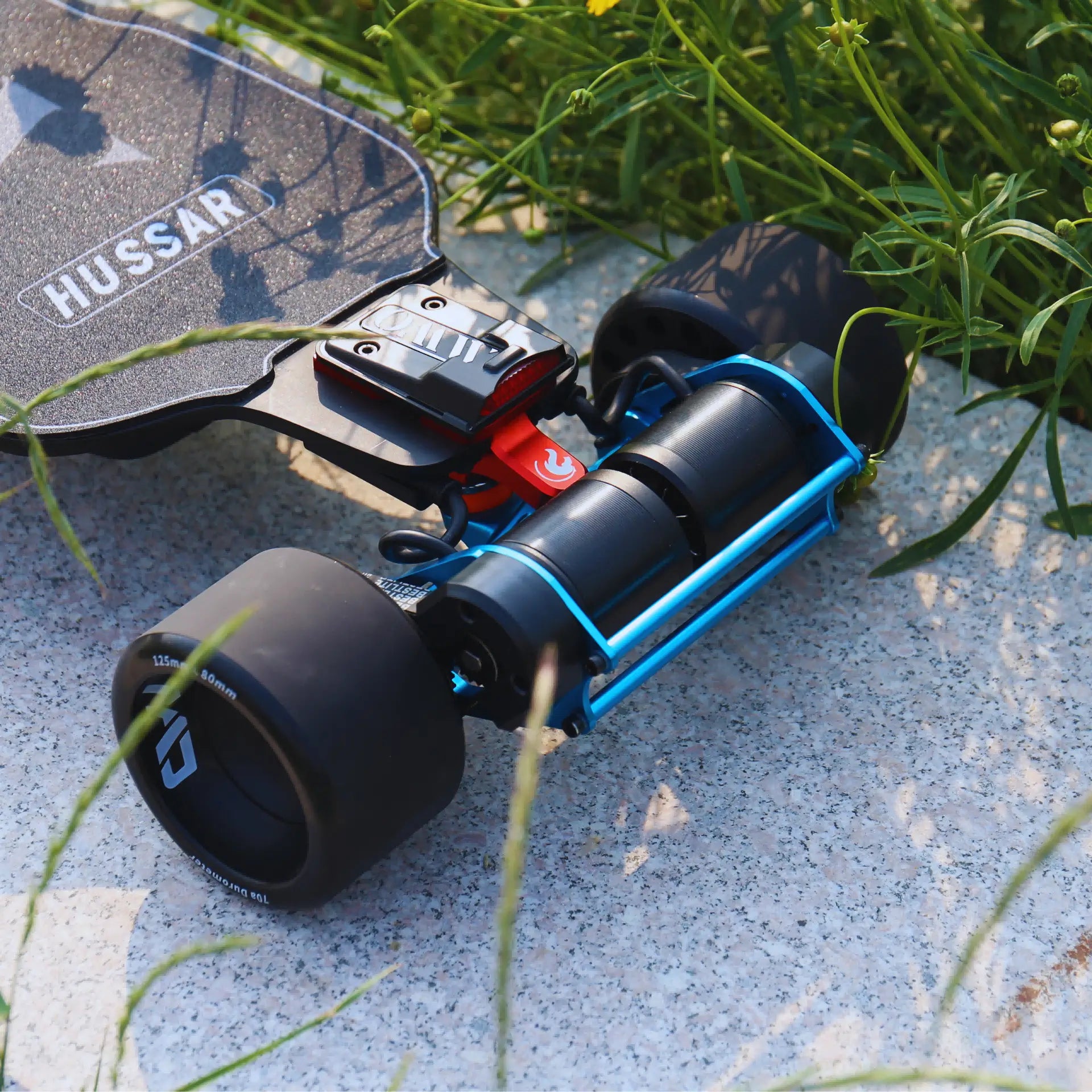 Hussar electric skateboard with colored CMC trucks and motor mount