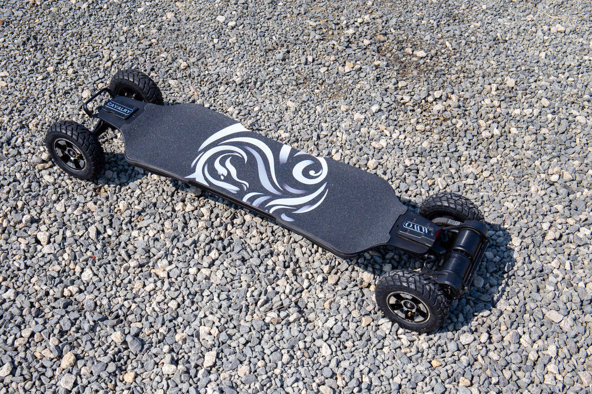 OMW Cavalry electric skateboard with 175 mm pneumatic wheels and belt drive on dry gravel