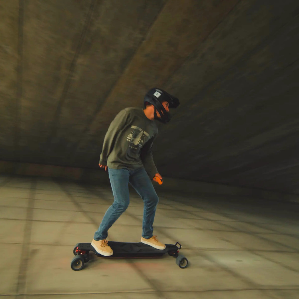 A man riding on OMW Lancer electric skateboard with a black deck