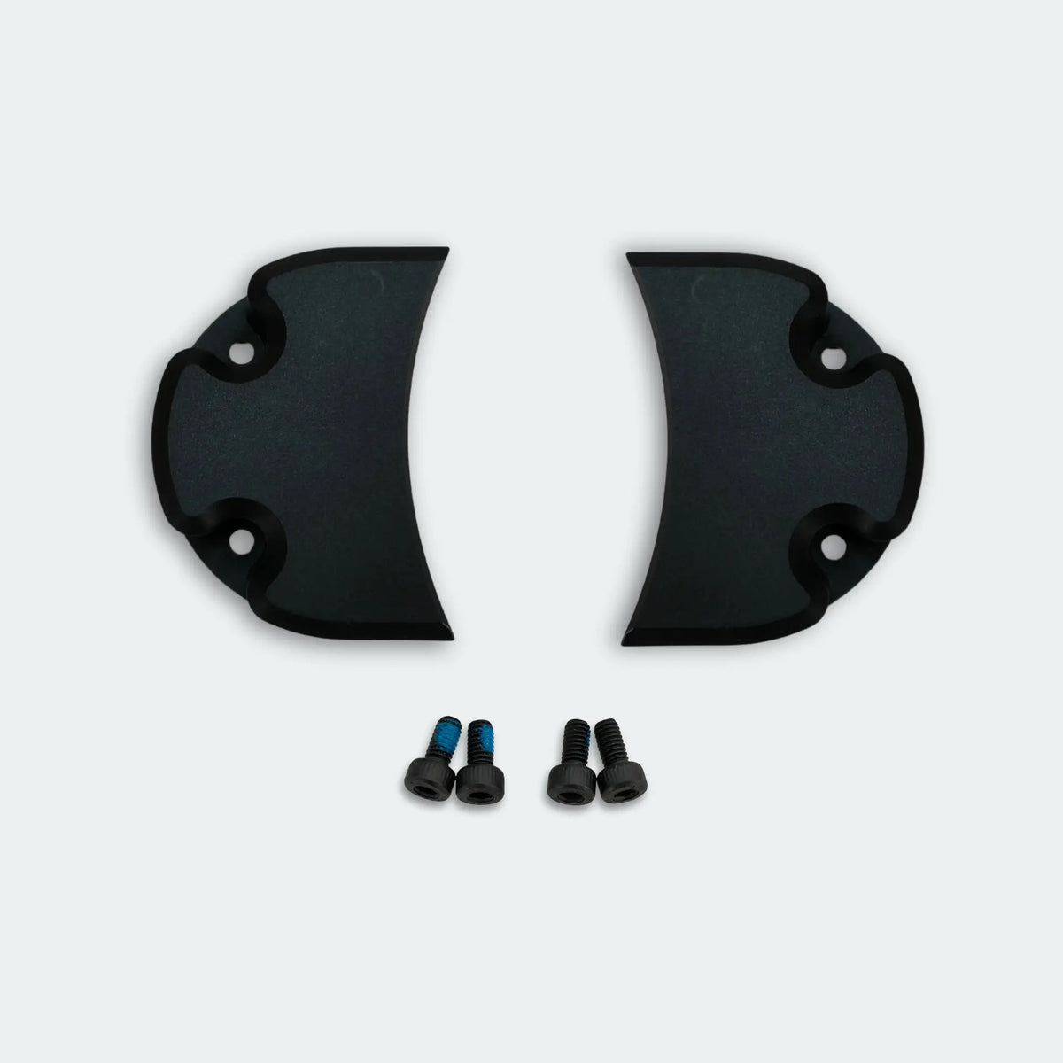 Two black plastic belt covers with screws on a white background