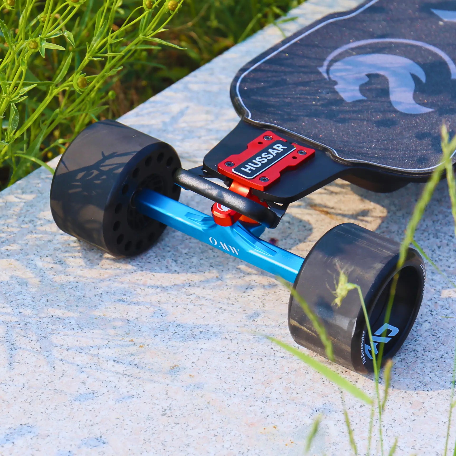 Hussar electric skateboard with colored CMC trucks